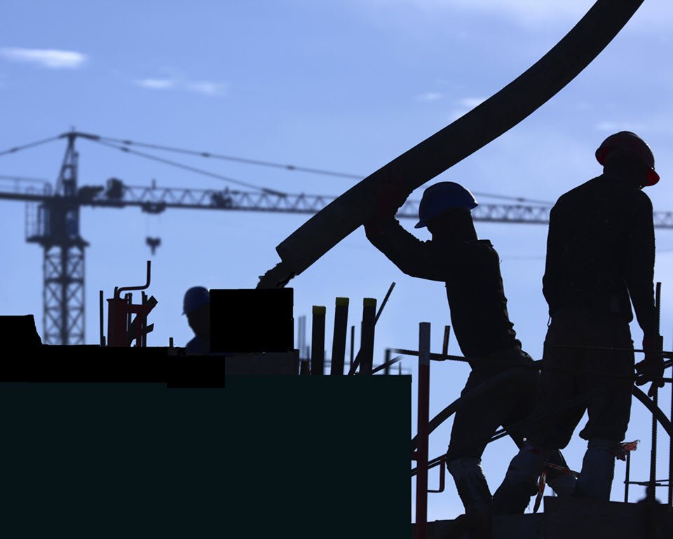 construction workers building a facility with cement-related materials