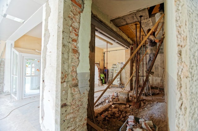 internal wall and ceiling of a habitational building being finalized by construction workers