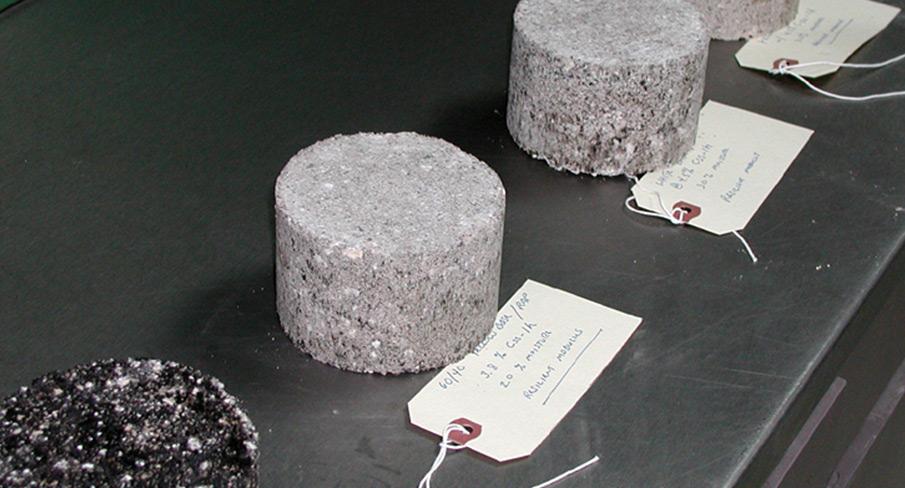 Concrete test samples at Kiwa KOAC with identification tags on a lab table, ready for analysis